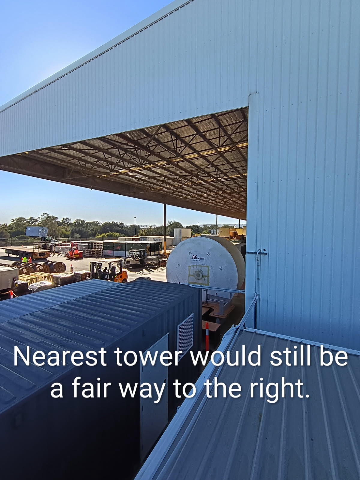 Warehouse rooftop view at Perth Airport industrial precinct showing steel structures obstructing the donor antenna path toward the nearest Telstra mobile tower