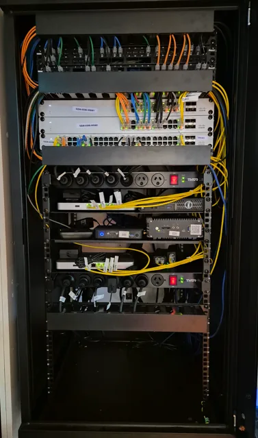 Cabinet after reset: organised, labelled patch leads